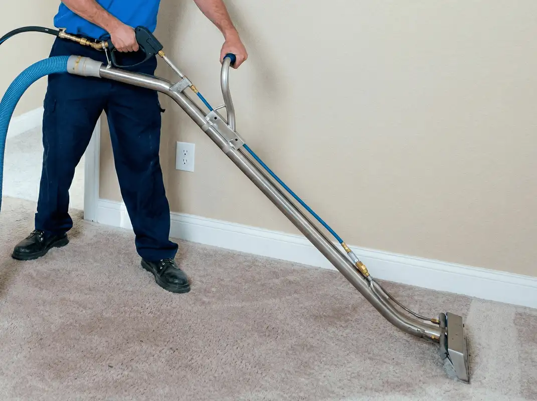 Professional operating a liquid removal machine on a carpeted floor in San Francisco, CA