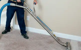 Professional operating a liquid removal machine on a carpeted floor in San Francisco, CA